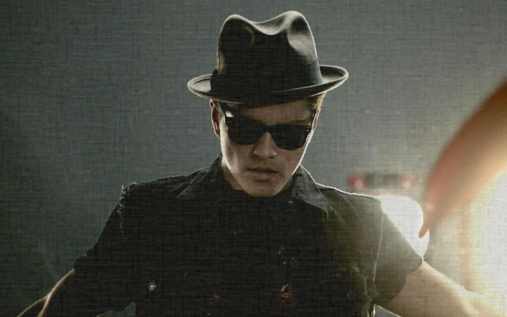 Moody Bruno Mars unplugged portrait with dark hat sunglasses backlit gray textured background Wallpaper