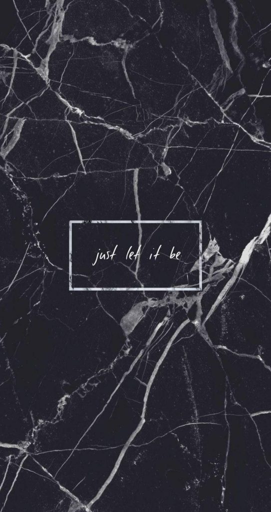 Dark marble wallpaper with white veining and handwritten cursive just let it be text in frame