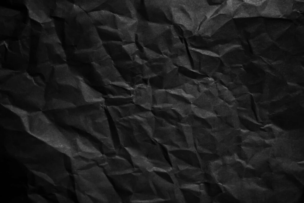 Dramatic Dark Crumpled Paper Texture Wallpaper Background