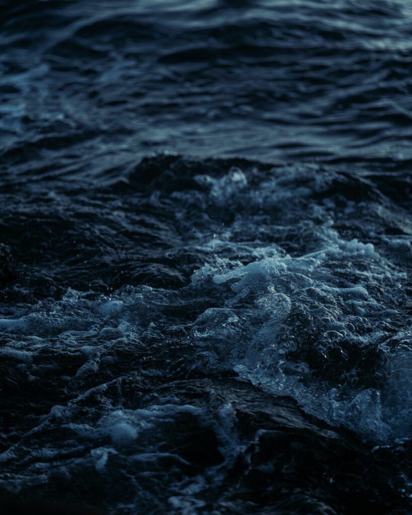 Moody ocean wallpaper with deep blue dynamic waves textured water background for sea lovers
