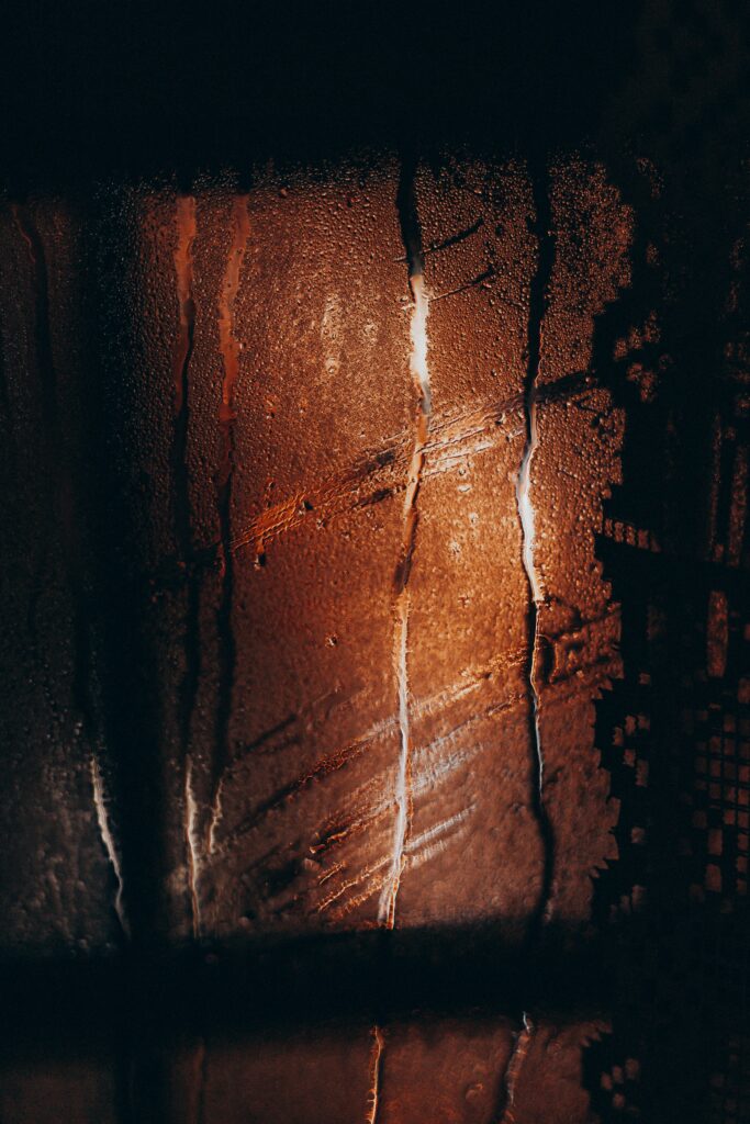 Moody Wallpaper: Fogged Glass with Water Drops & Warm Light Aesthetic