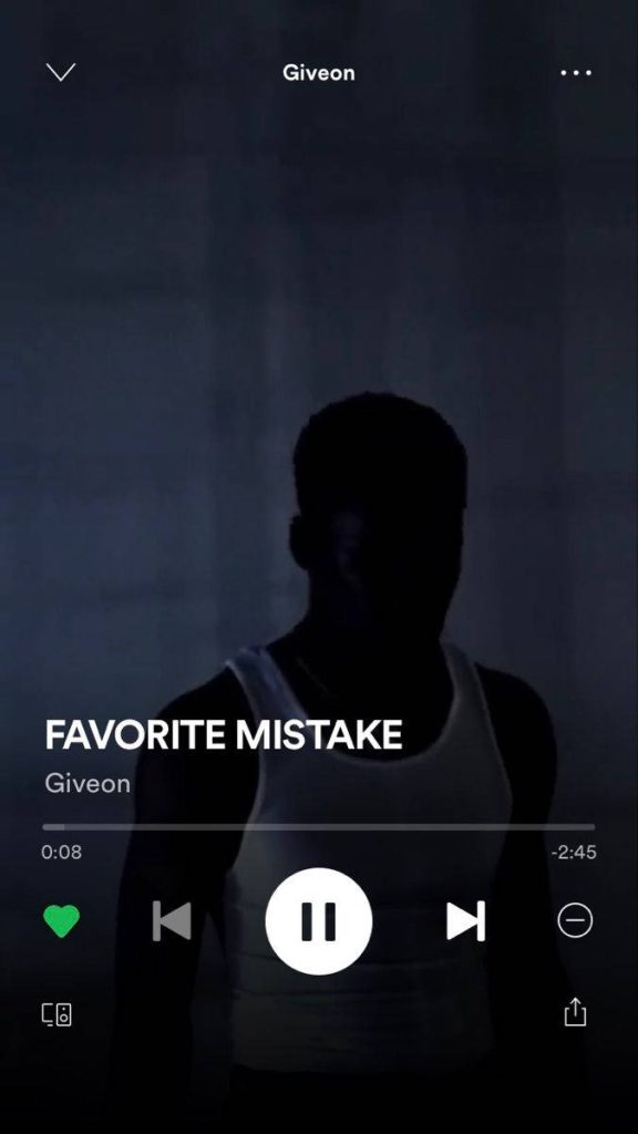 Moody dark wallpaper of R&B singer Giveon in silhouette with Spotify 