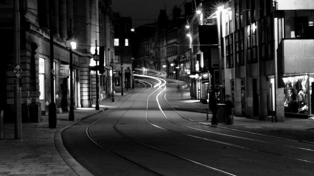 Serene Grayscale Wallpaper: Tranquil Dark City Street with Tram Tracks