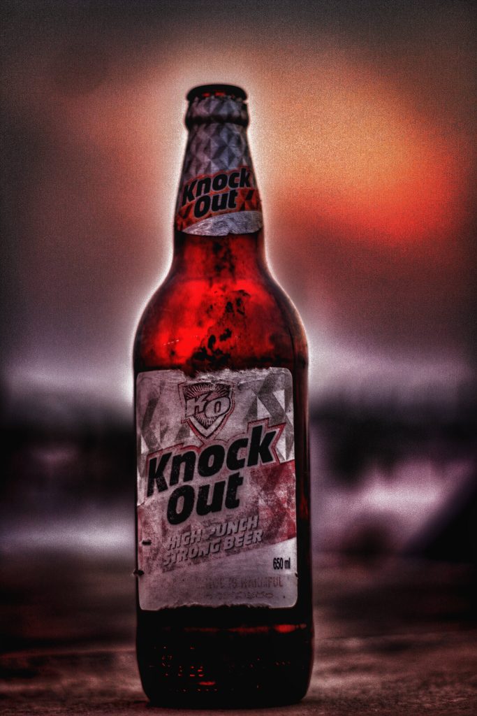 High contrast Knock Out High Punch Strong Beer 650ml bottle with red orange backlight wallpaper