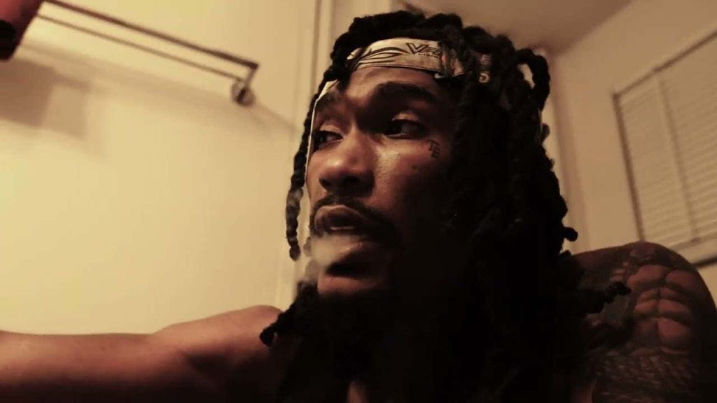 Hunxho rapper moody wallpaper warm dim light locs headband smoke tattoos artistic background