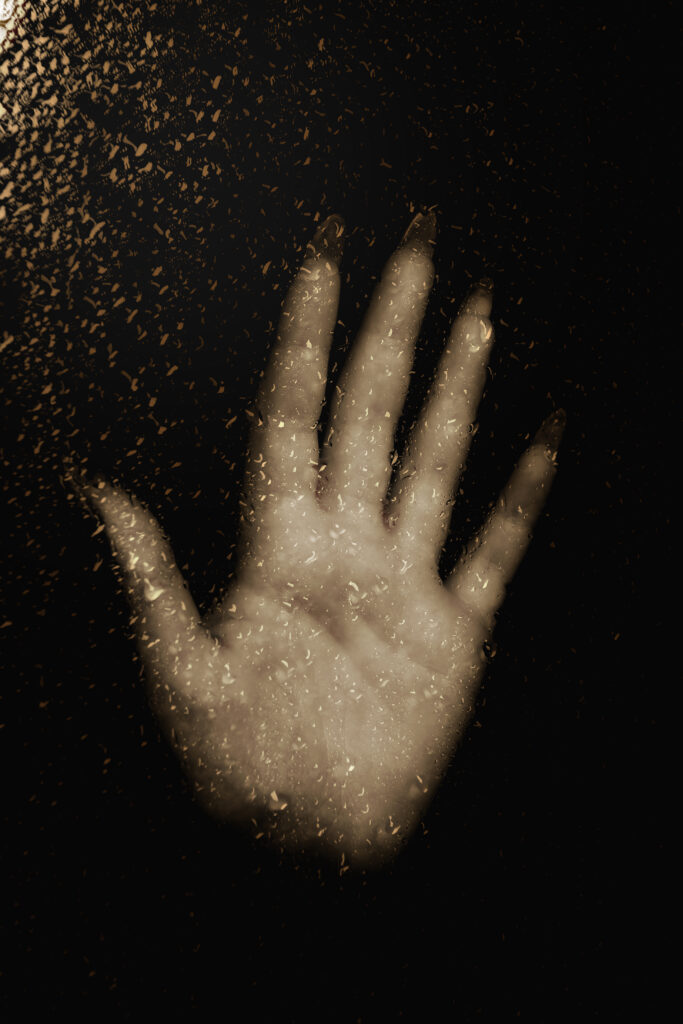 Moody Macro Wallpaper: Hand on Glass with Light-Droplets
