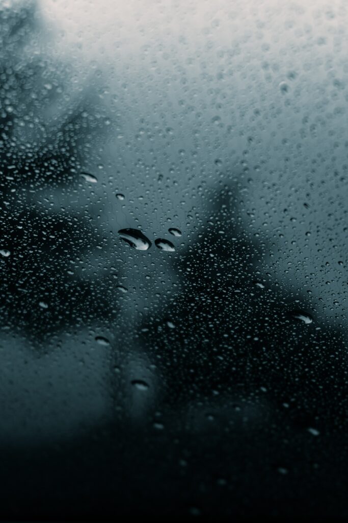 Moody Macro Wallpaper: Water Droplets on Glass with Blurred Outdoors