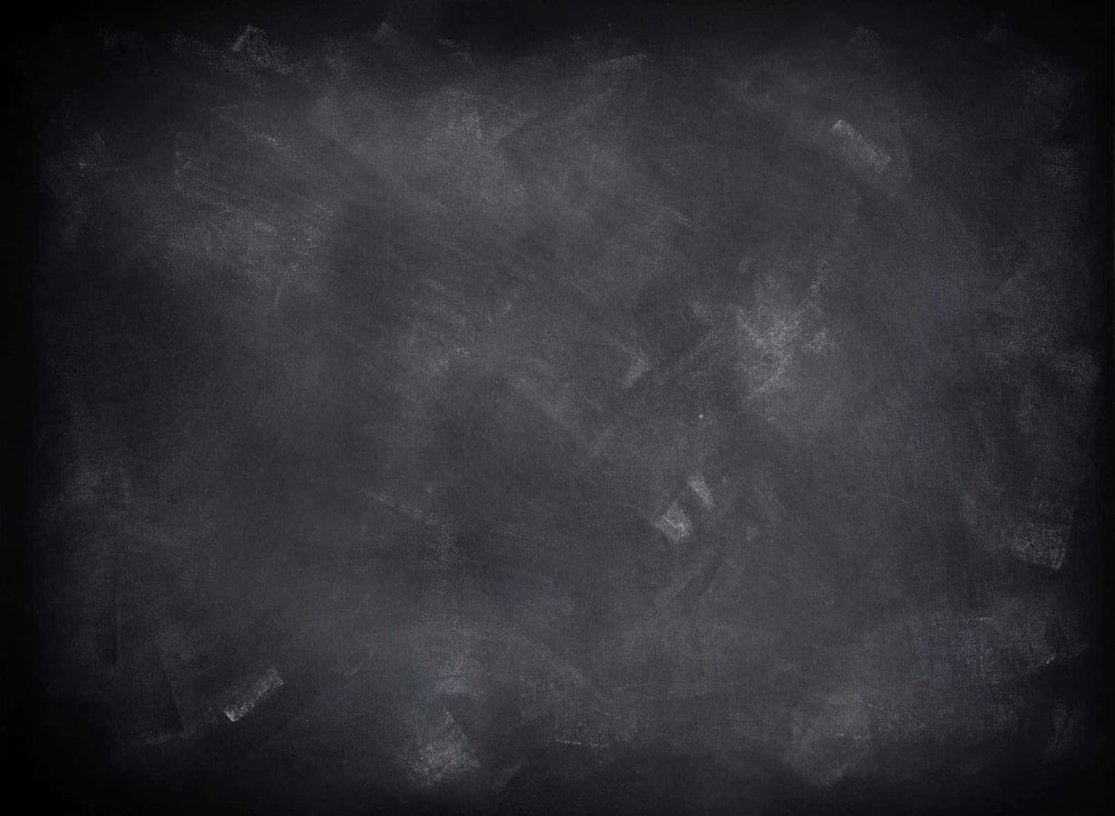 Dark matte slate chalkboard with textured white chalk smudges for creative educational backgrounds Wallpaper