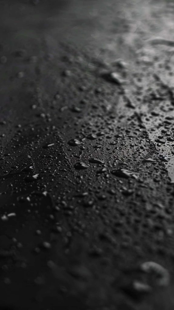 Macro photo of realistic water droplets on textured black surface minimalist phone wallpaper background