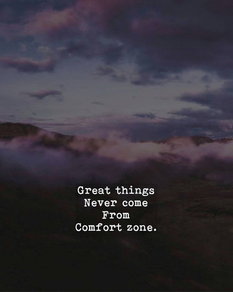 Moody mountain landscape wallpaper with dark clouds misty peaks and inspiring growth quote overlay