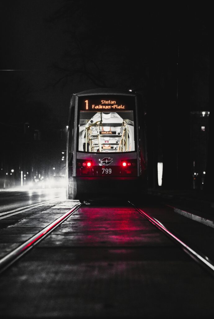 Moody Nighttime Cityscape Wallpaper: Tram & Glowing Lights