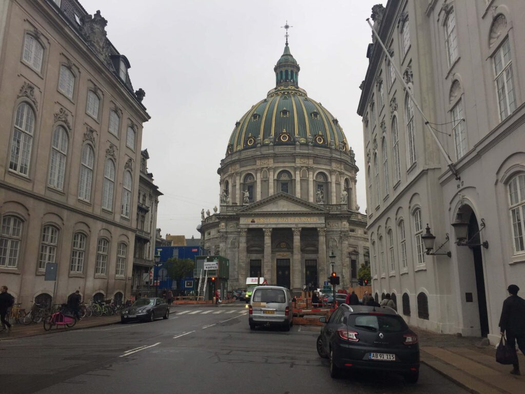 Moody overcast sky over Amalienborg Palace Copenhagen with iconic dome and classical architecture Wallpaper