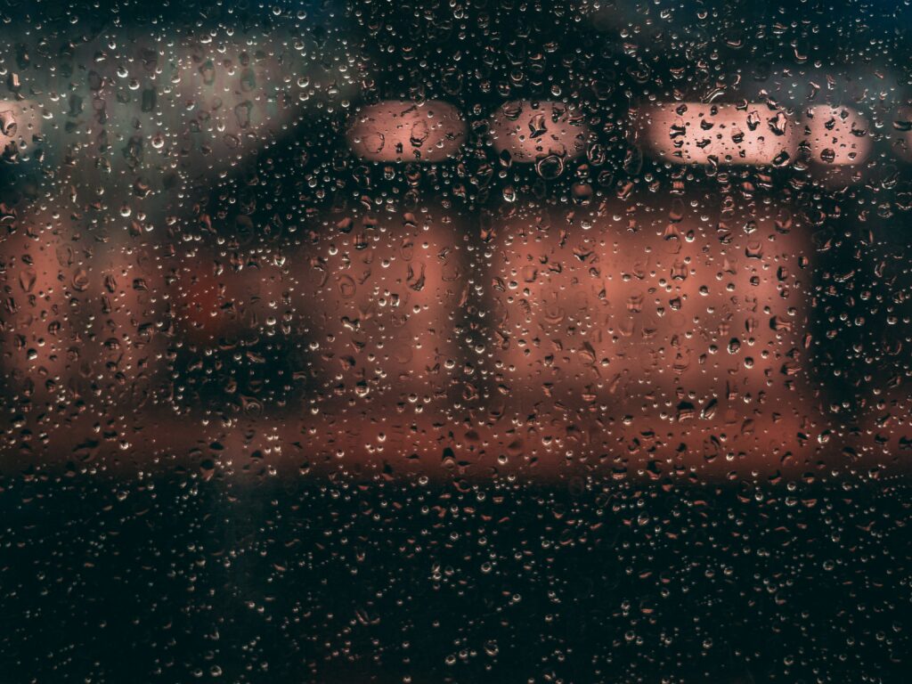 Moody Raindrop Wallpaper: Soft Blur with Warm Ambient Lights