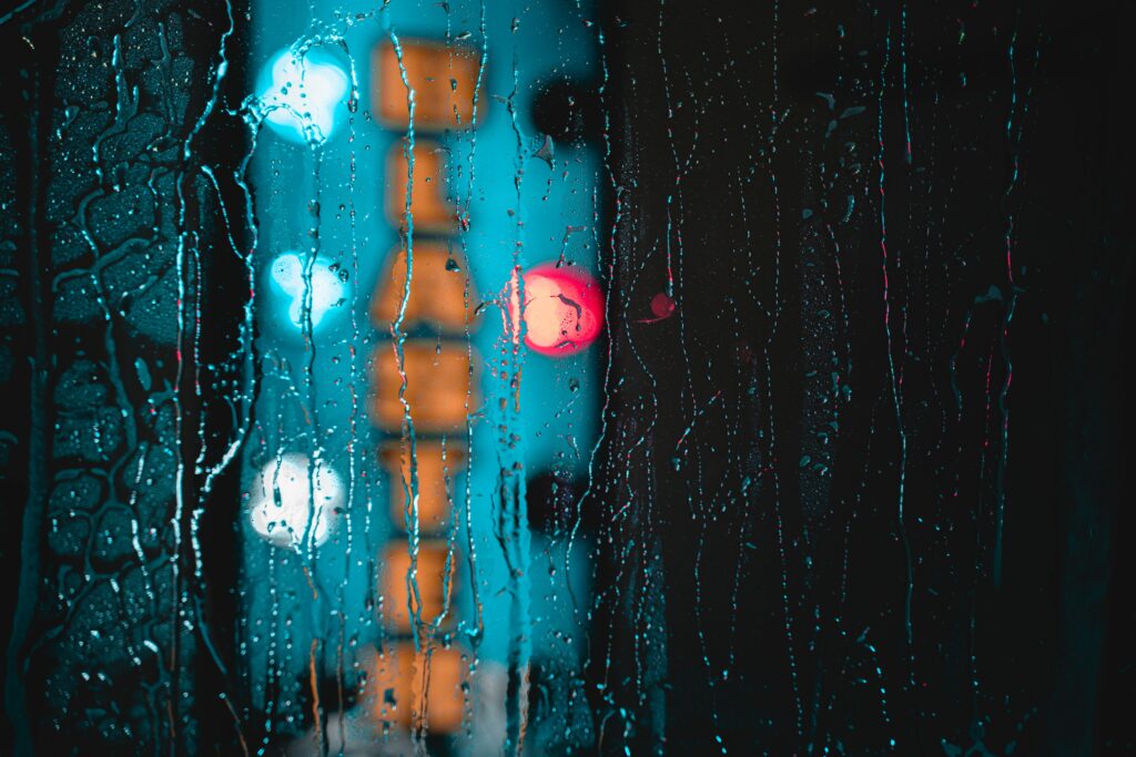 Moody Rainy Wallpaper: Glass Droplets & Blurred Colorful Lights