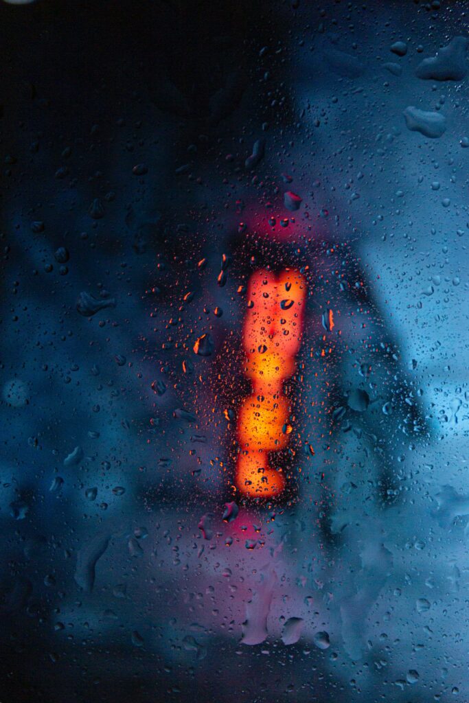 Moody Wallpaper: Vibrant Blurred Rain-Covered Glass Background