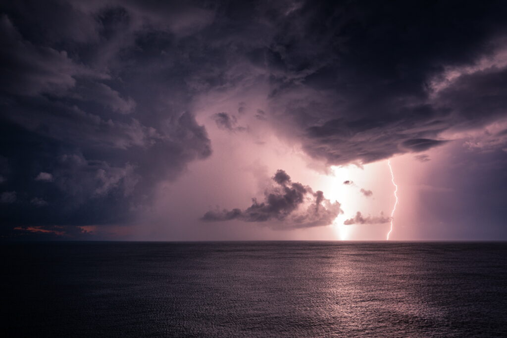 Stunning HD Wallpaper: Lightning Over Sea with Dramatic Clouds