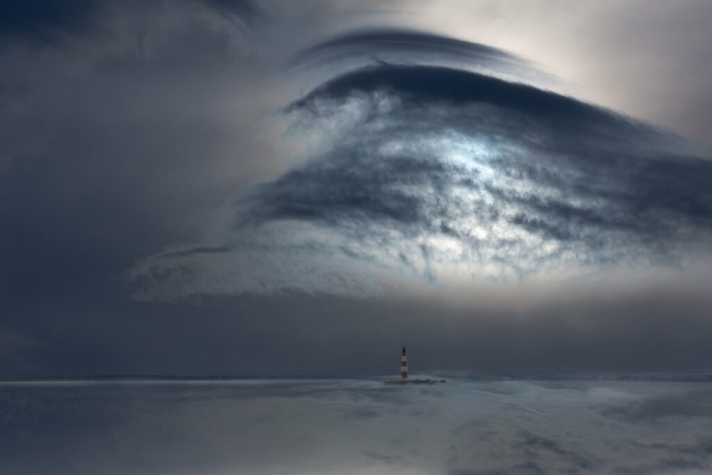 Moody Seascape Wallpaper: Lighthouse Against Dark Turbulent Skies