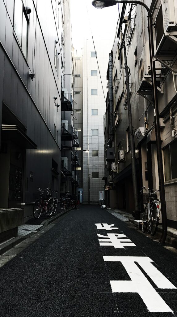 Moody Urban Alleyway Wallpaper: Captivating Cityscape Background