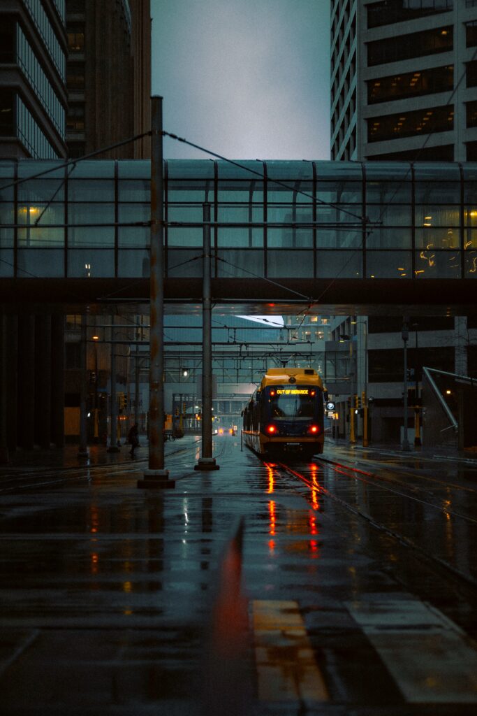 Moody Urban Rainy Evening: Train, Reflections, and Skywalk Wallpaper