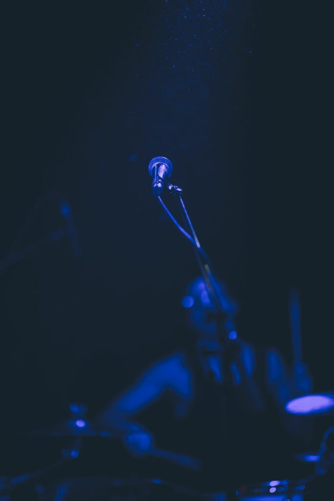 Moody Concert Wallpaper: Spotlighted Microphone in Dark Atmosphere