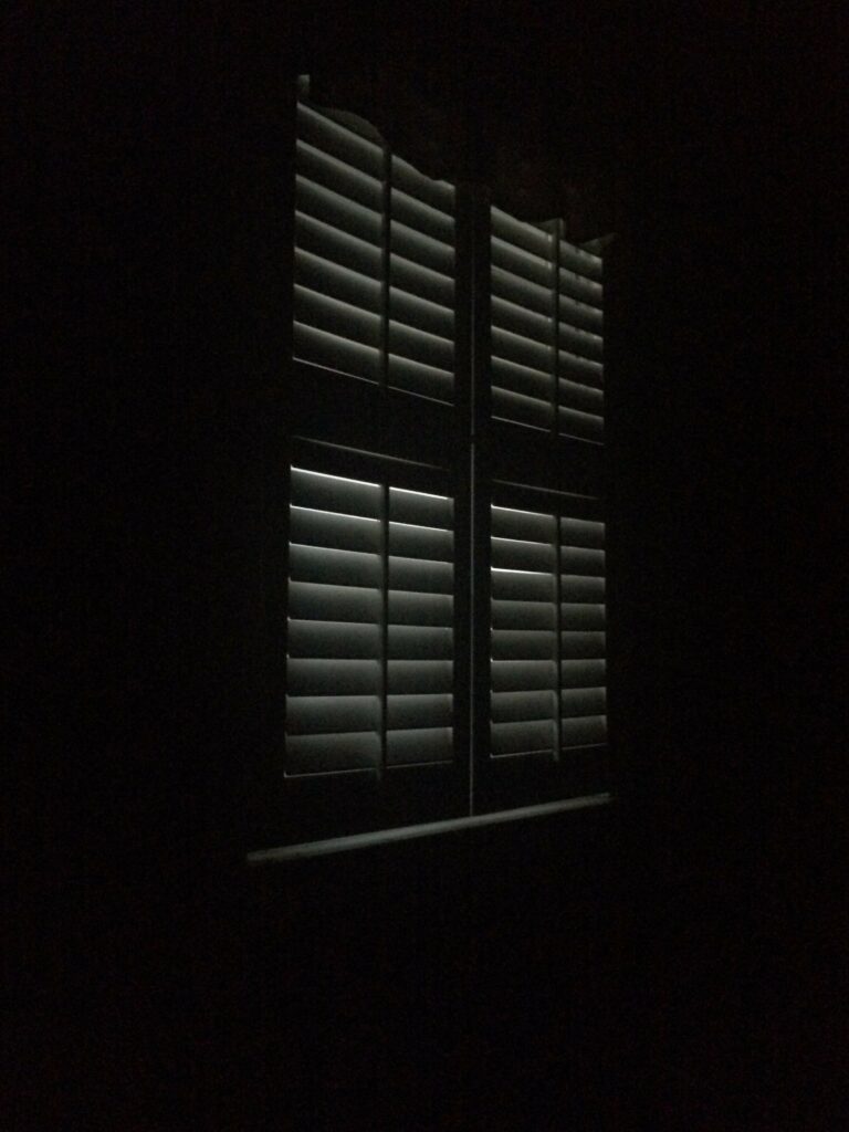 Moody Window Wallpaper: Mysterious Scene with Subtle Light Streaks