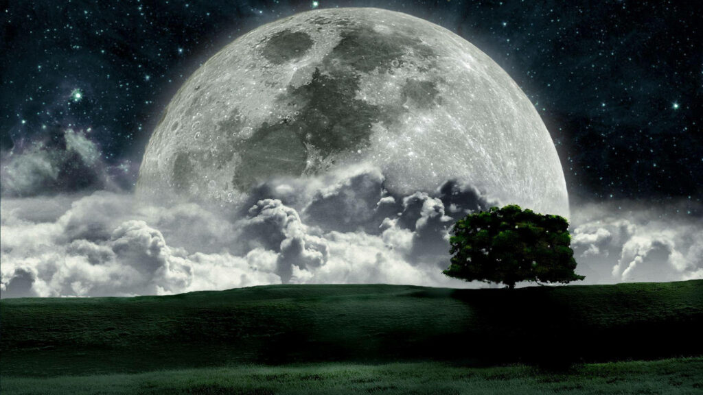 Mystical full moon over dark grassy hill with solitary tree and dramatic clouded night sky wallpaper