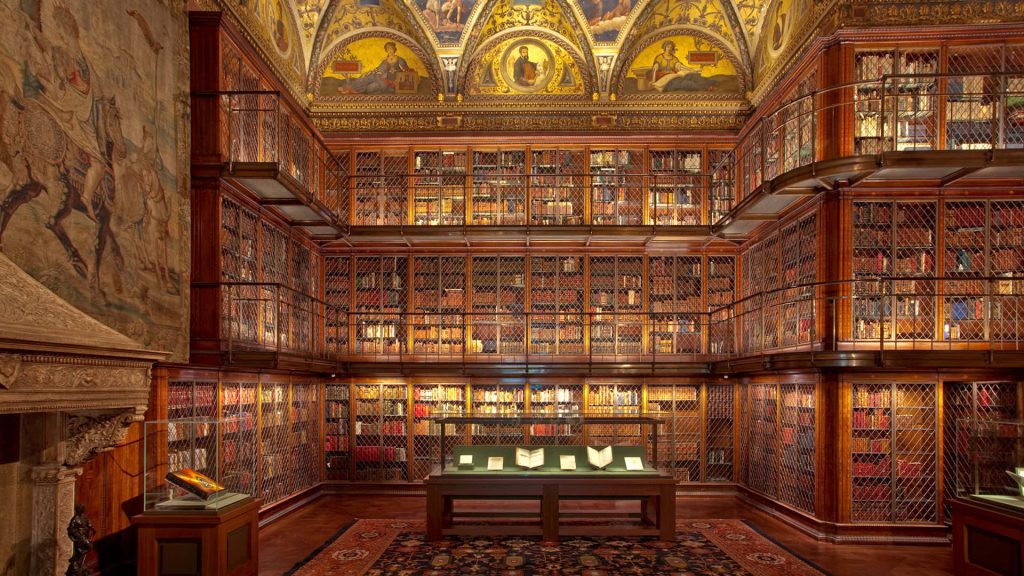 Symmetrical Morgan Library room with ornate frescoes and books behind lattice doors wallpaper background