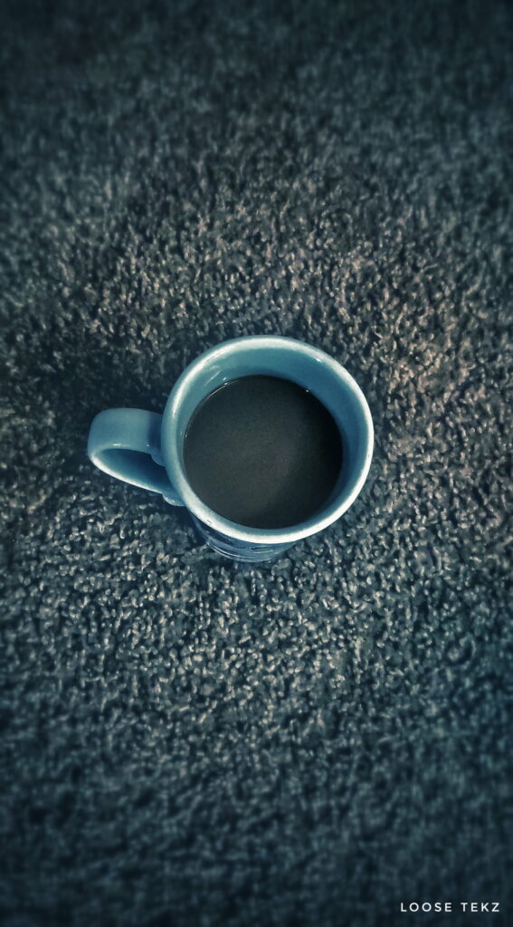 Cozy blue coffee mug on textured grey carpet low-light wallpaper Galaxy Note 9 background