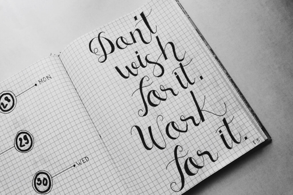 Monochrome Motivational Wallpaper: Handwritten Quote on Notebook Page