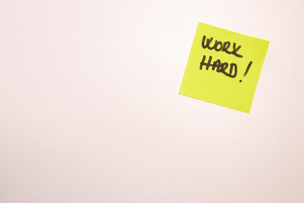 Motivating Neon Sticky Note Reminder on Minimalist Laptop Background Wallpaper