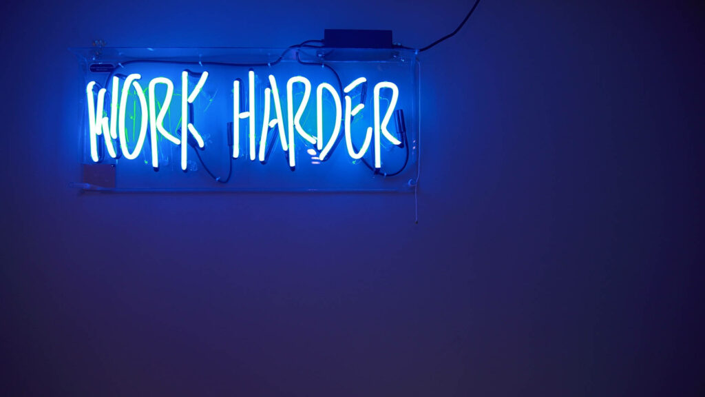 Motivational Neon Sign: Amplify Your Efforts in High-Definition Blue Wallpaper