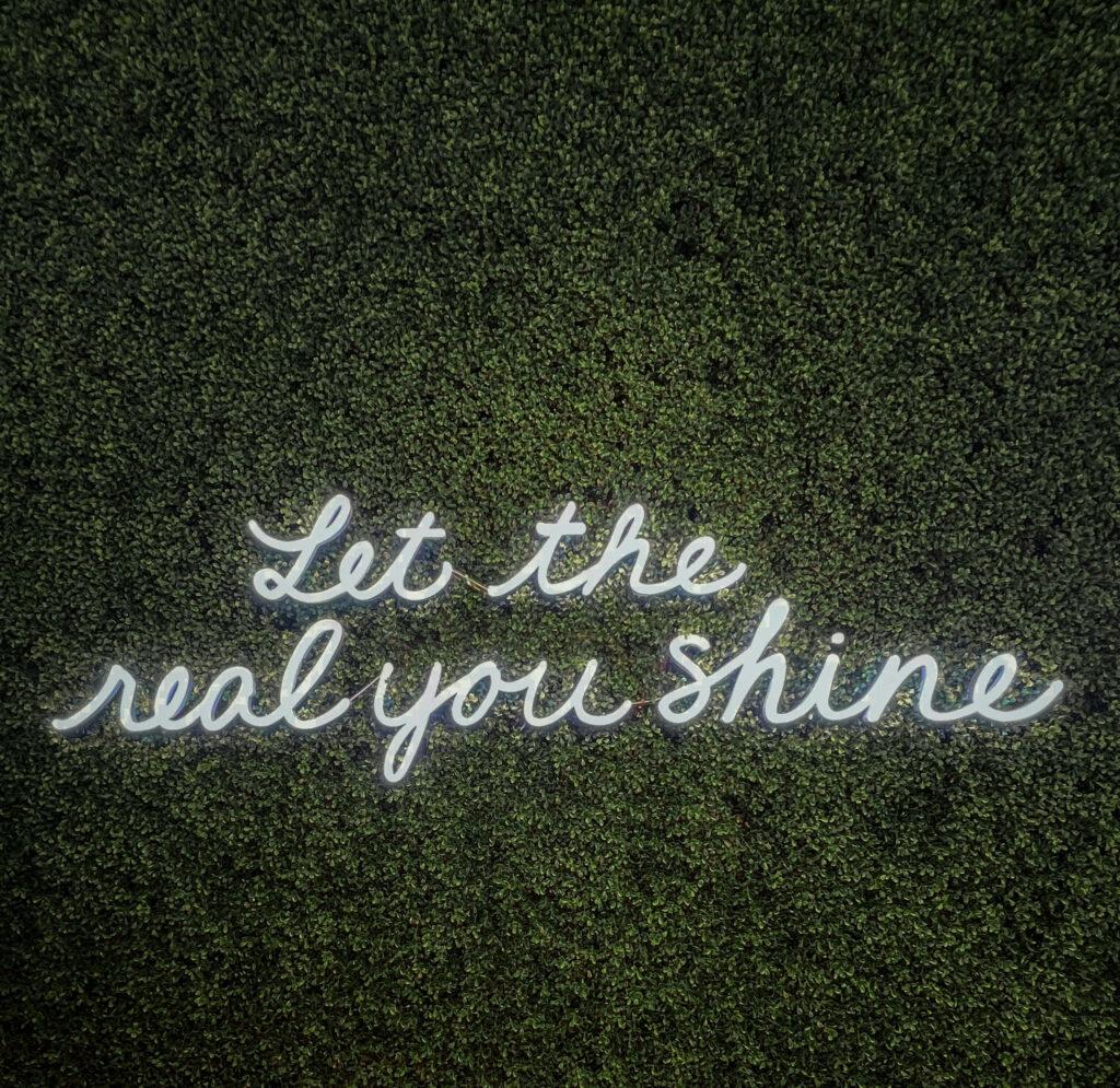 Motivational Quote in White Neon on Lush Green Textured Background Wallpaper