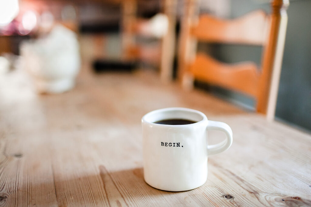 Motivational Wallpaper: White Cup with Dark Beverage on Wooden Table