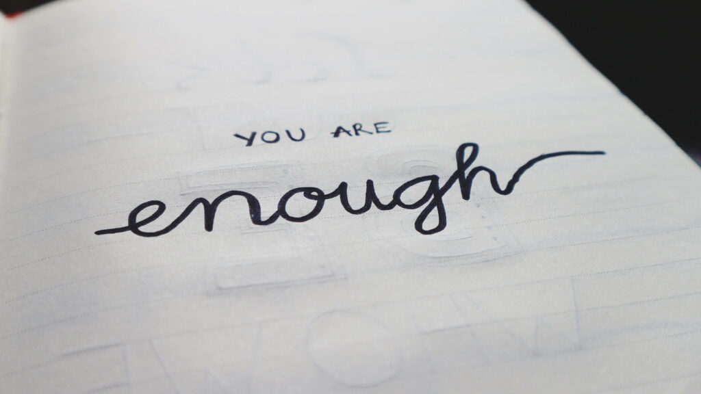 Motivational Wallpaper: 'You Are Enough' Notebook Close-Up