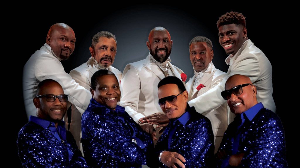 Motown legends The Four Tops and The Temptations in blue sequins and white blazers on black background Wallpaper