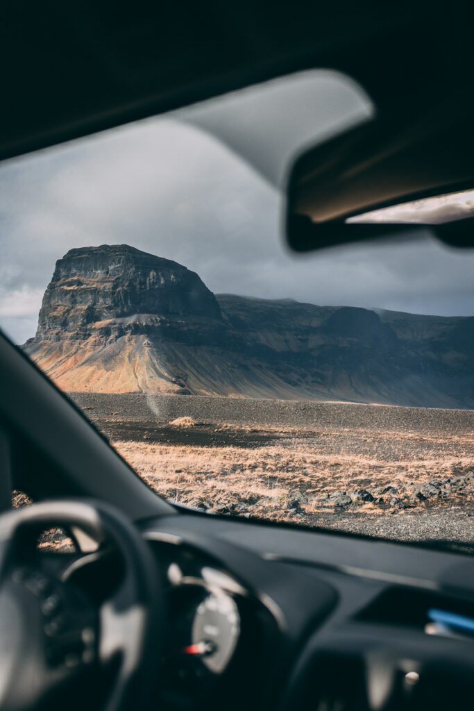 Mountain landscape viewed through car window earth tones travel adventure wallpaper background