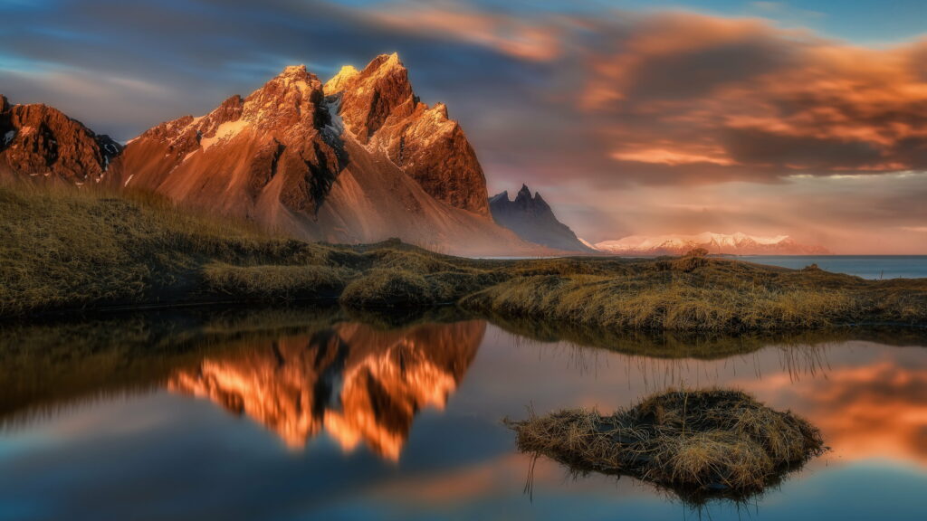 Reflections of the Majestic Mountains: A Breathtaking 4K Wallpaper of a Serene Landscape with a Body of Water and Clouds