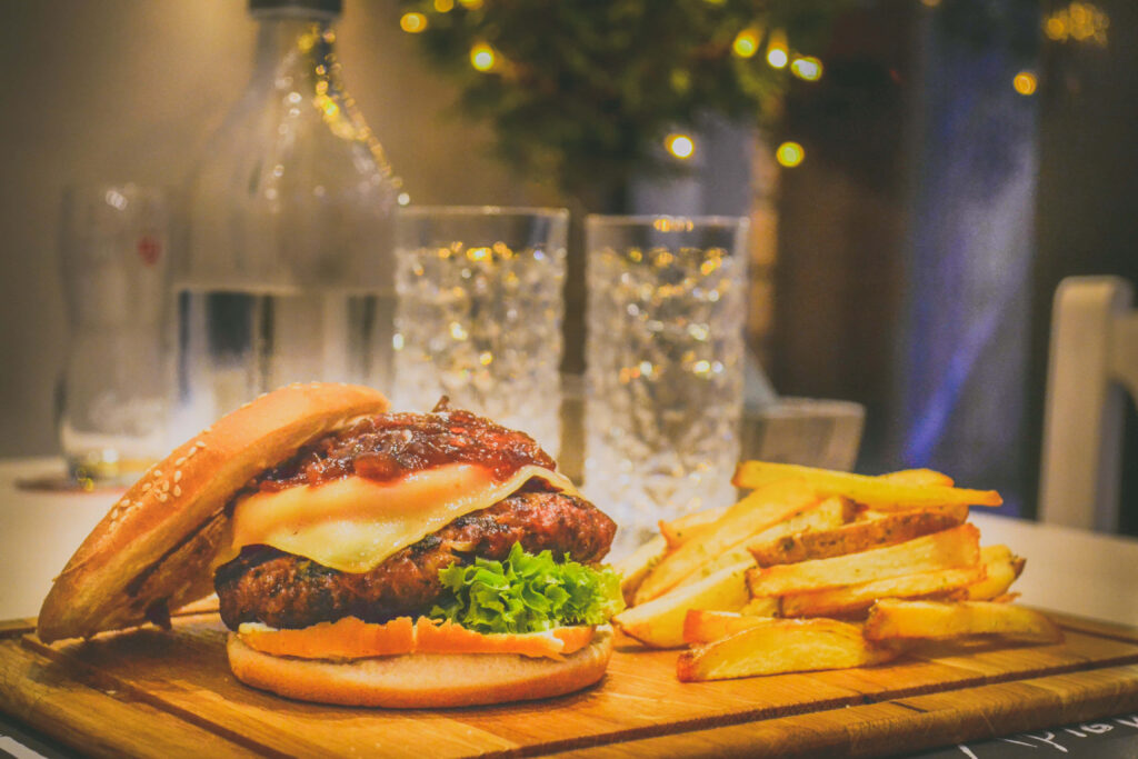 Delicious Burger with Cheese & Fries - Mouthwatering Wallpaper Background