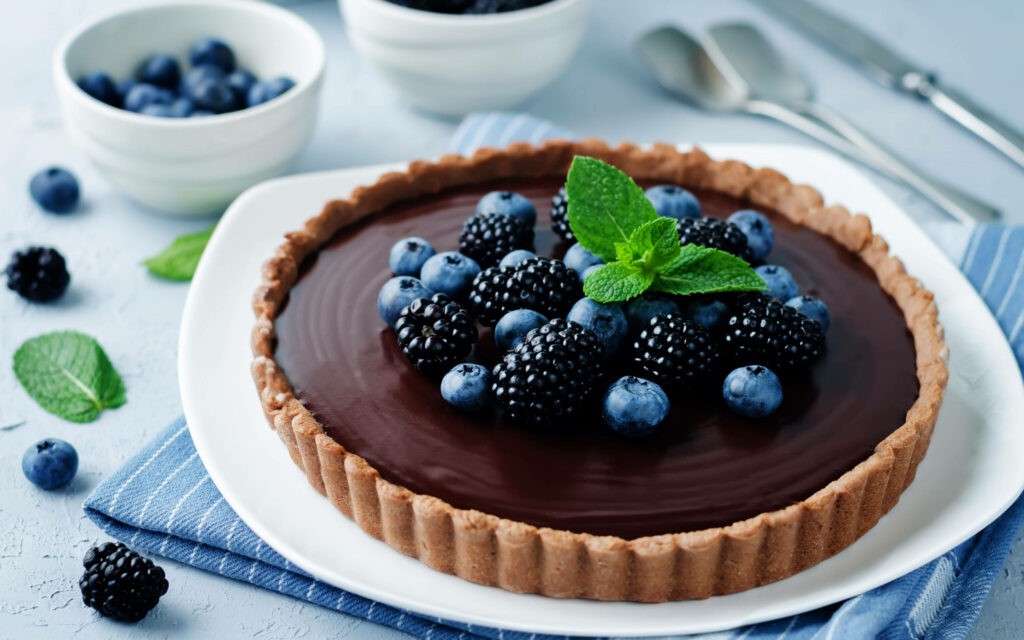 Decadent Chocolate Tart Delight with Fresh Berry Medley Wallpaper