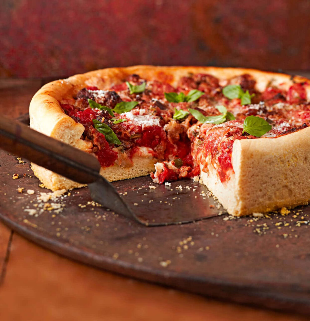 Delicious Deep-Dish Pizza with Fresh Basil – Rustic Wallpaper Background