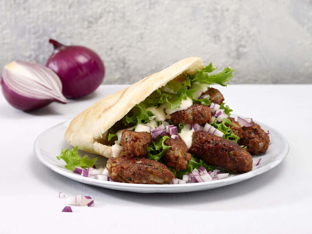 Delicious Ćevapi Sausages in Flatbread: Rustic Wallpaper Background