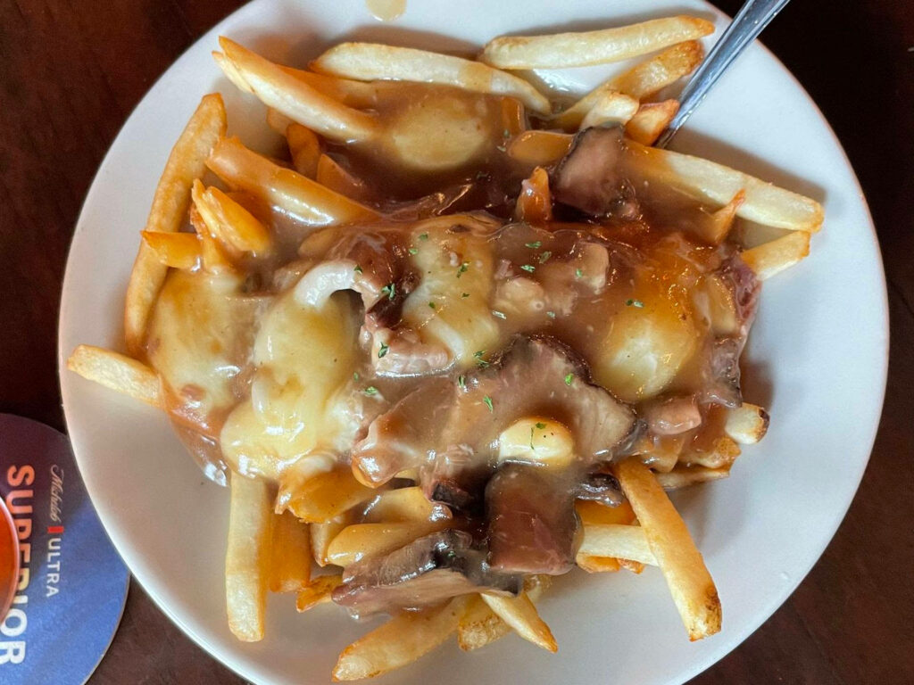 Delicious Poutine Wallpaper: Loaded Fries with Gravy & Cheese