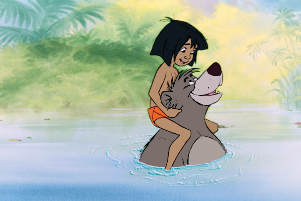 Mowgli riding Baloo through clear jungle water surrounded by lush green foliage wallpaper background