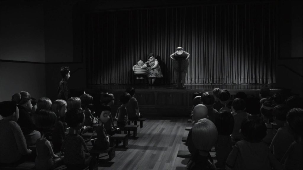 Black and white Frankenweenie wallpaper with Mr Rzykruski at podium in moody assembly hall