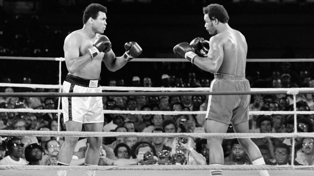 Muhammad Ali and George Foreman intense boxing moment during 1974 Rumble in the Jungle fight Wallpaper