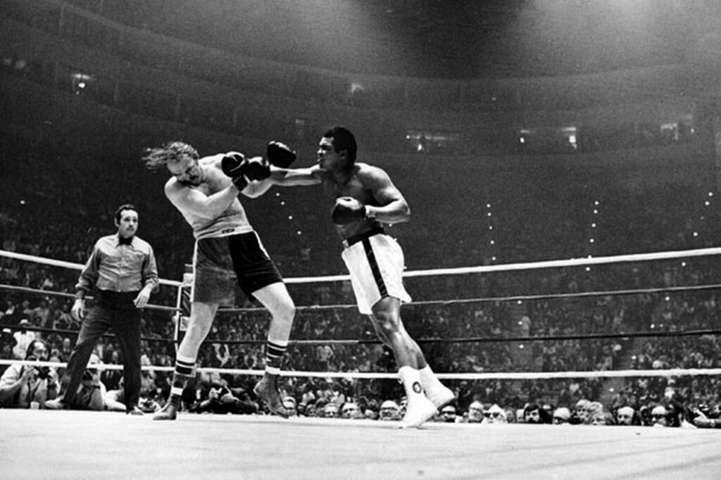 Iconic Muhammad Ali Punch Wallpaper: Power & Skill in the Ring