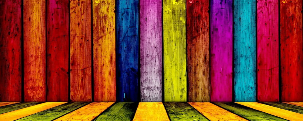 Vibrant rainbow wooden plank wallpaper with vertical colorful boards and realistic grain texture