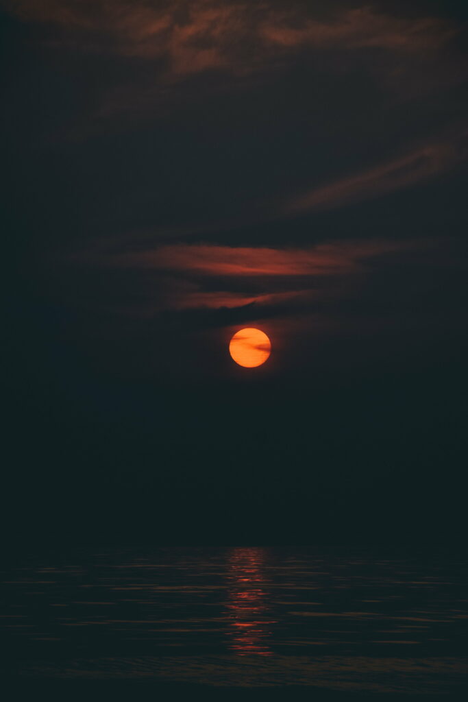 Mumbai's Mystical Moonlit Ocean with a Stunning Sunset Sky: A Captivating HD Phone Wallpaper
