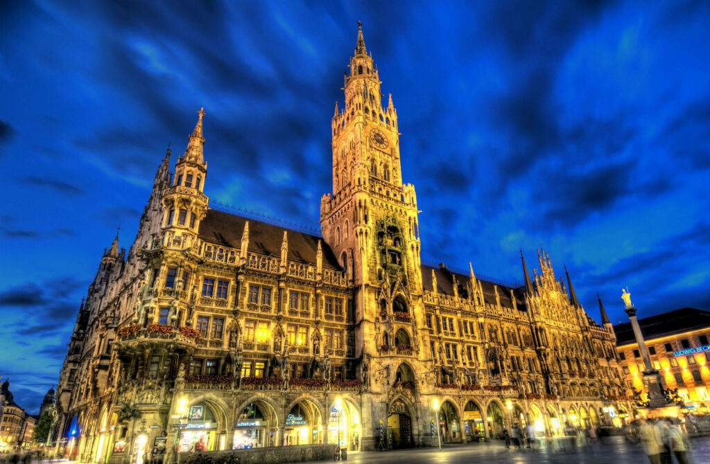 Gothic Town Hall Munich illuminated at dusk with detailed architecture and vibrant city atmosphere Wallpaper