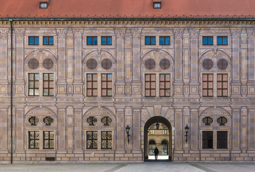 Munich Residenz ornate Renaissance facade with symmetrical windows and detailed stonework wallpaper